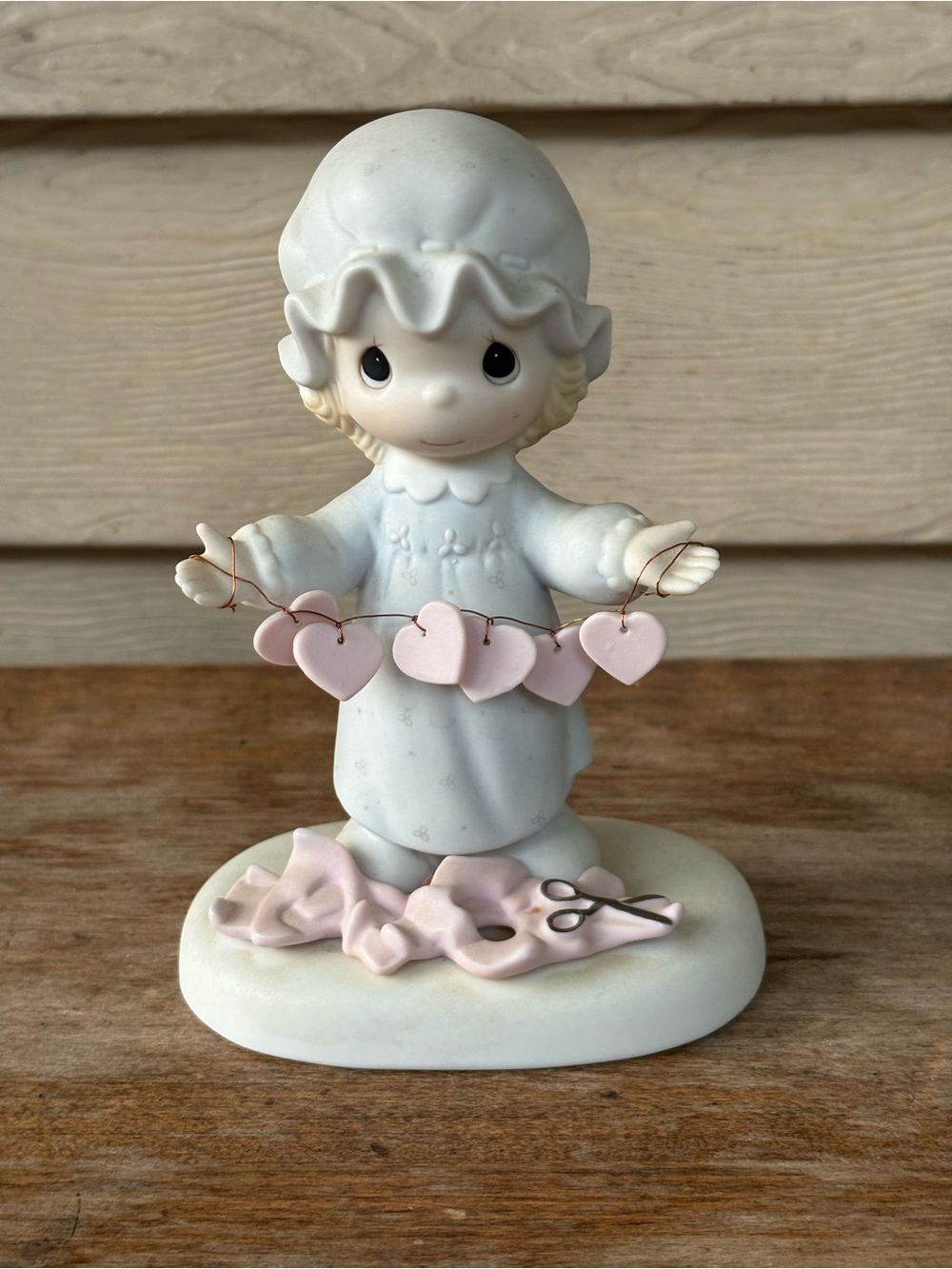 Precious Moments porcelain figurine titled "You Have Touched So Many Hearts".
